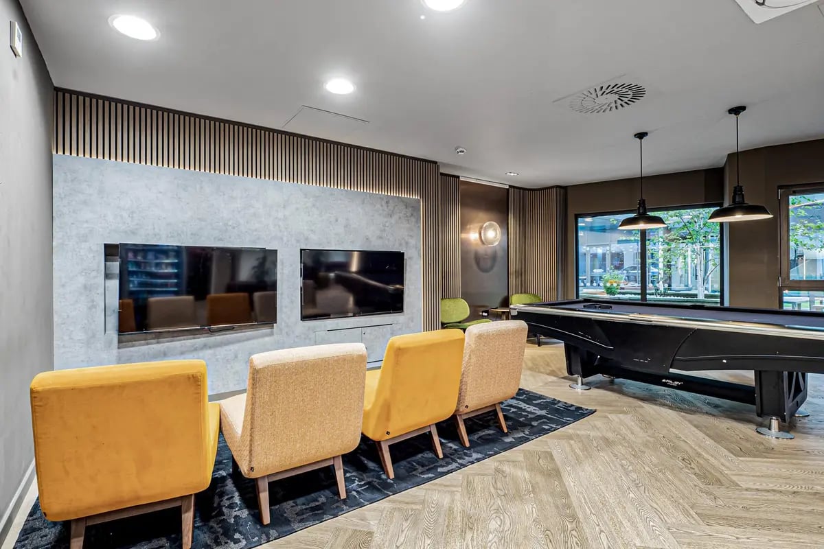 TVs chairs pool table lounge area at Chapter Old Street in London Student Accommodation