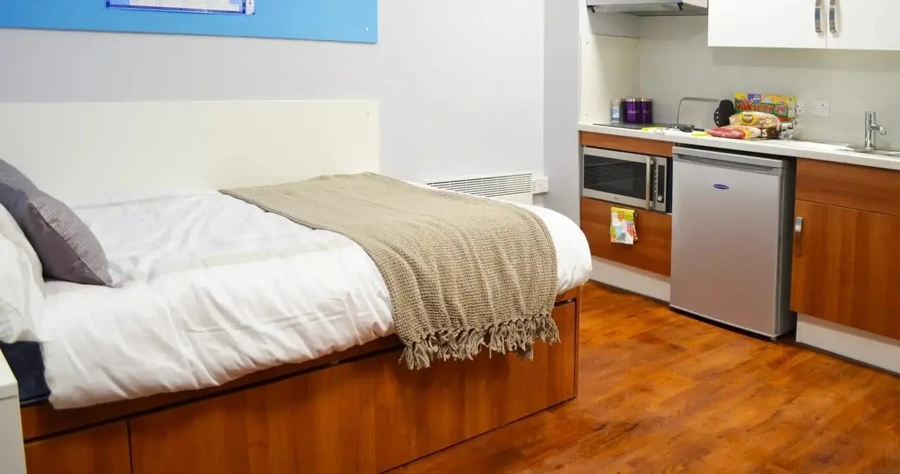 Bed microwave fridge kitchen and bedroom at Kaplan Living Nottingham in Nottingham Student Accommodation