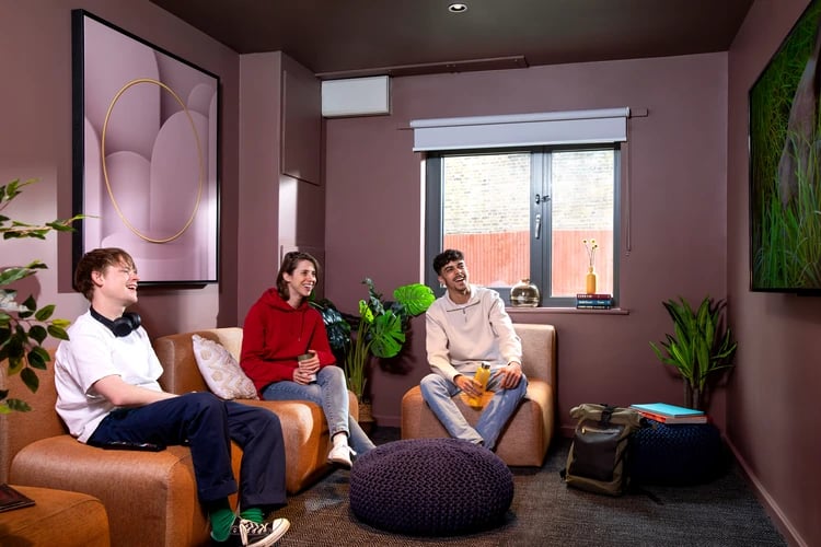 Students relaxing on sofas near window living room at Student Living Heights in London Student Accommodation