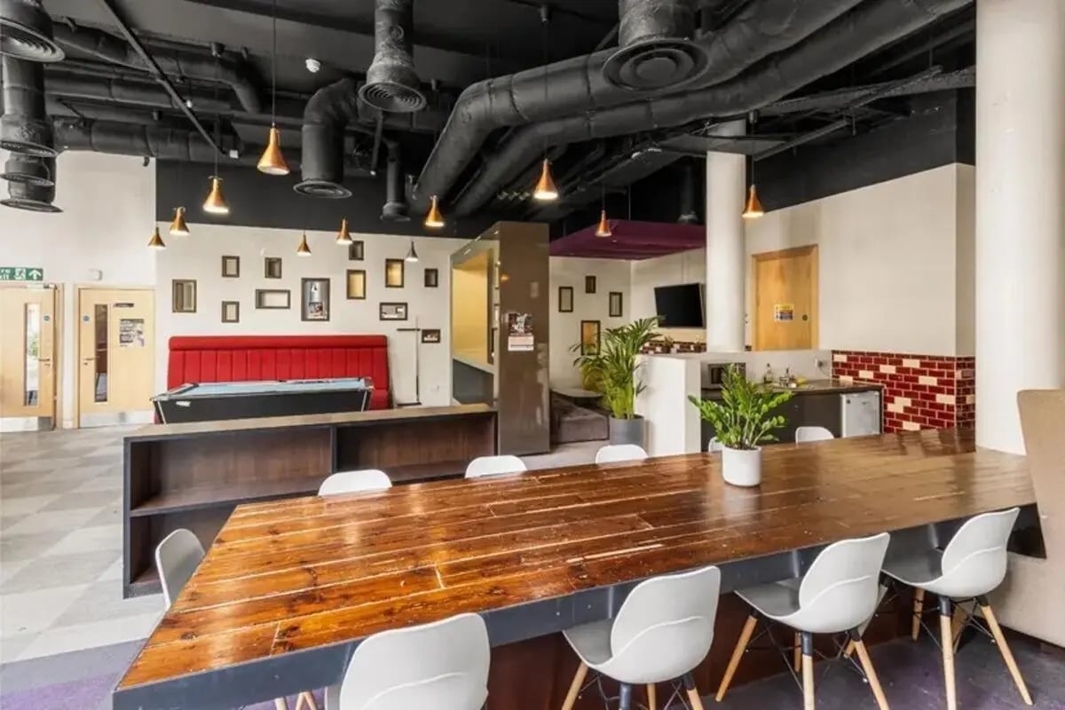Pool table red booth wood table white chairs common area at Chapter Highbury in London Student Accommodation