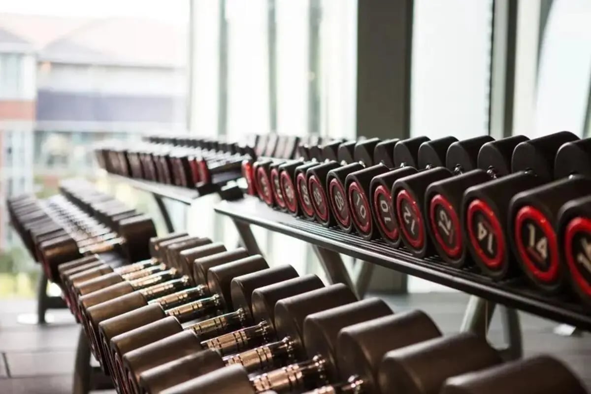 Rows of dumbbells with weights on racks gym at Chapter Highbury in London Student Accommodation