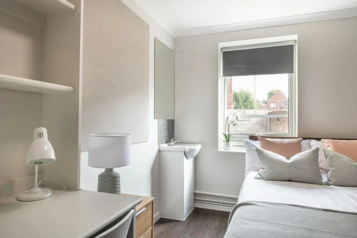 Desk lamp sink bed pillows bedroom at 4 Rob Roy House in Nottingham Student Accommodation