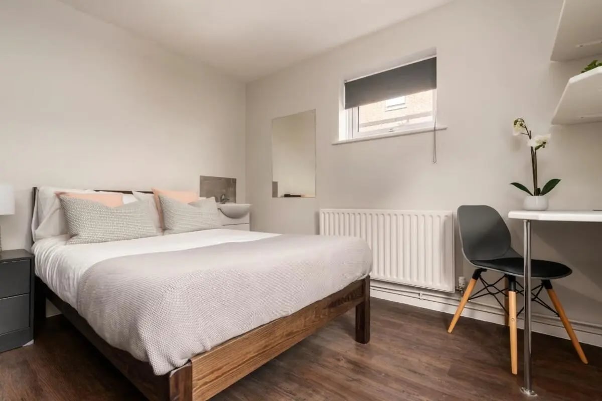 Bed sink desk chair and orchid bedroom at 28 Church Street in Nottingham Student Accommodation