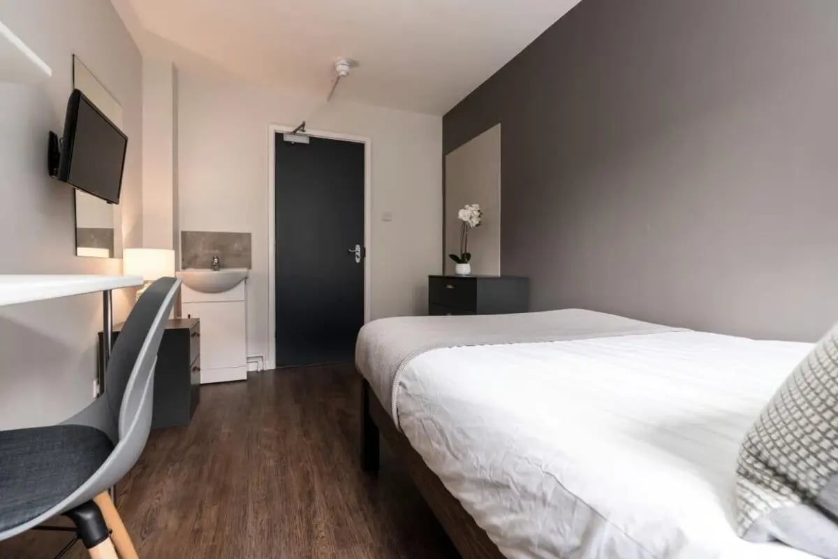 Bed sink desk TV and chair bedroom at 28 Church Street in Nottingham Student Accommodation