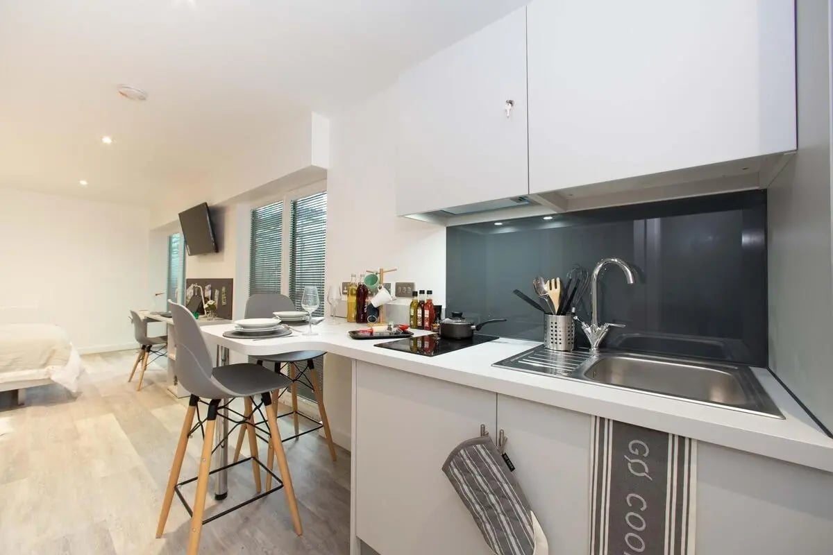 Kitchenette with sink stovetop and seating area kitchen at The Laceworks Nottingham in Nottingham Student Accommodation