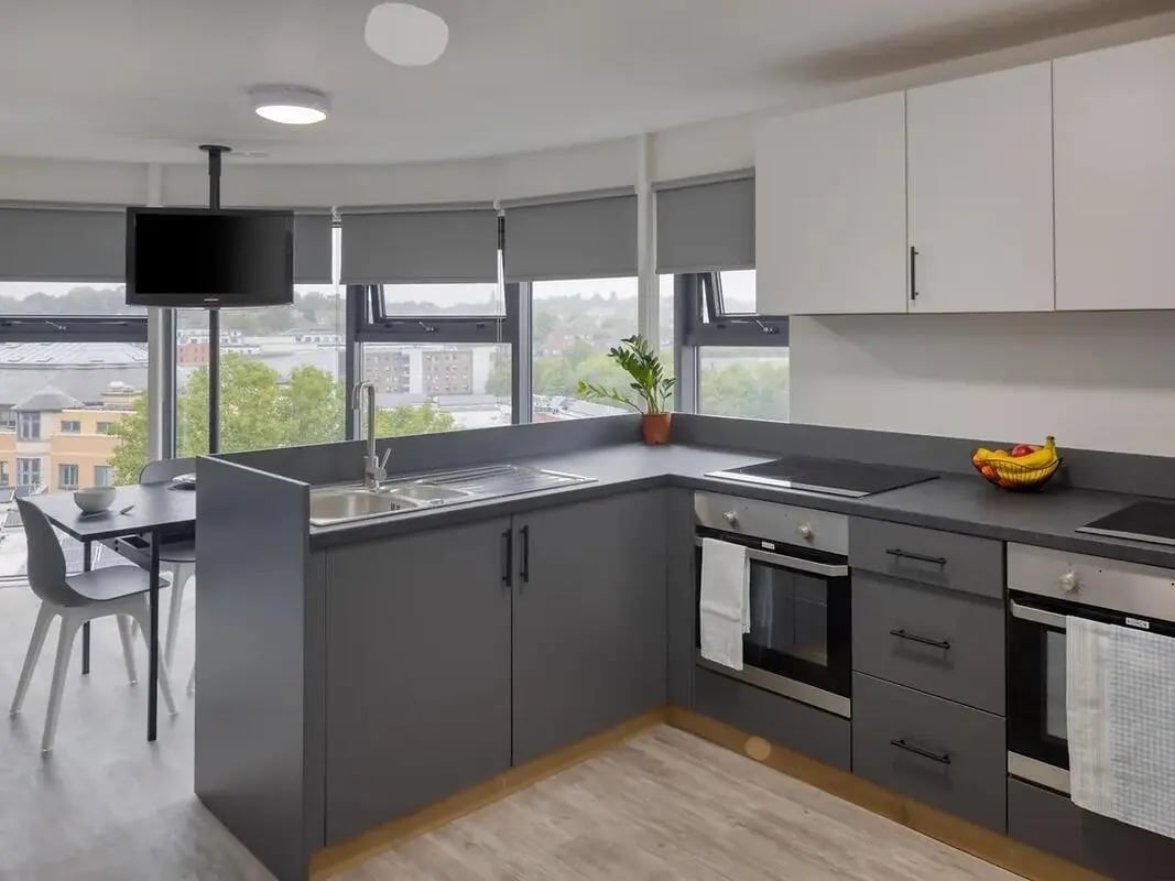 Modern kitchen with sink dining table and TV kitchen at Yugo Goldsmith Court in Nottingham Student Accommodation