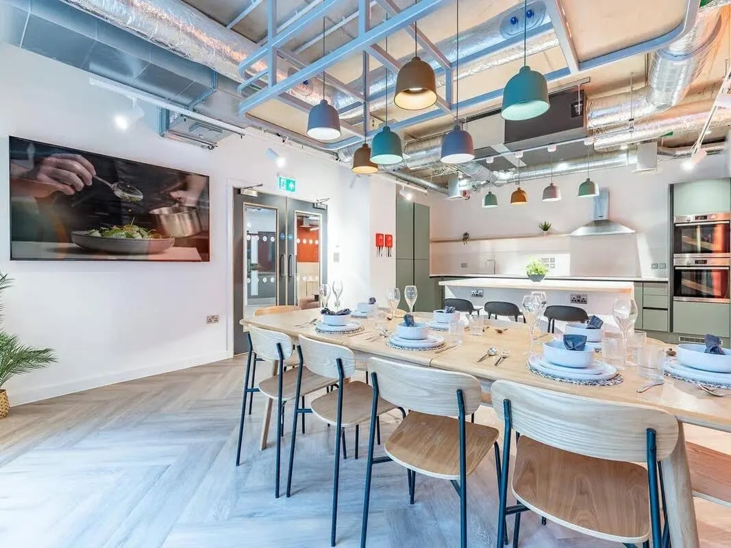 Dining table with place settings kitchen area exterior at Fabric in Nottingham Student Accommodation