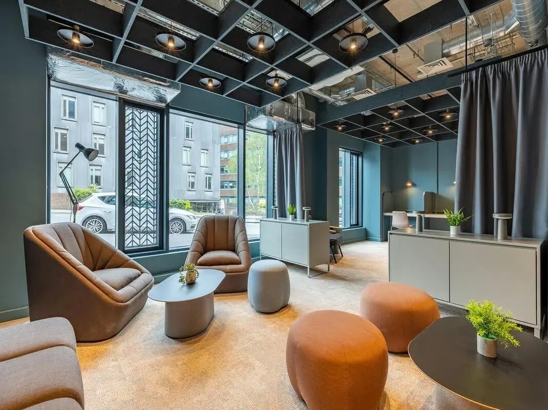 Chairs tables ottomans and desks common area at Fabric in Nottingham Student Accommodation