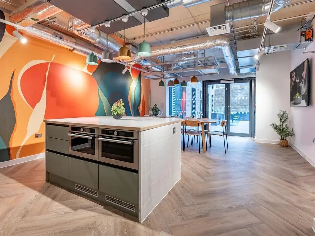 Kitchen island with ovens dining table and chairs kitchen at Fabric in Nottingham Student Accommodation