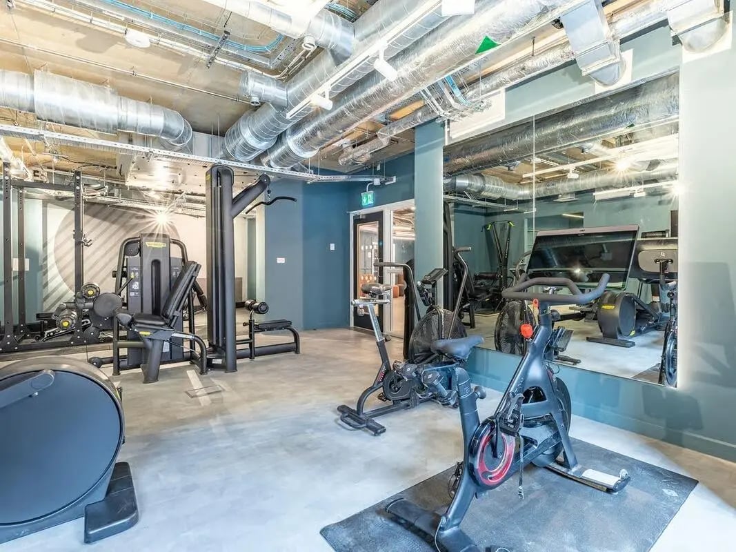 Gym equipment with exercise bikes and weights gym area at Fabric in Nottingham Student Accommodation