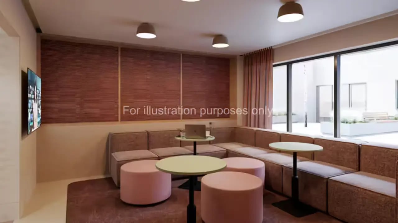 Lounge with sofas pink ottomans and laptop living room at The Malt Works in Edinburgh Student Accommodation
