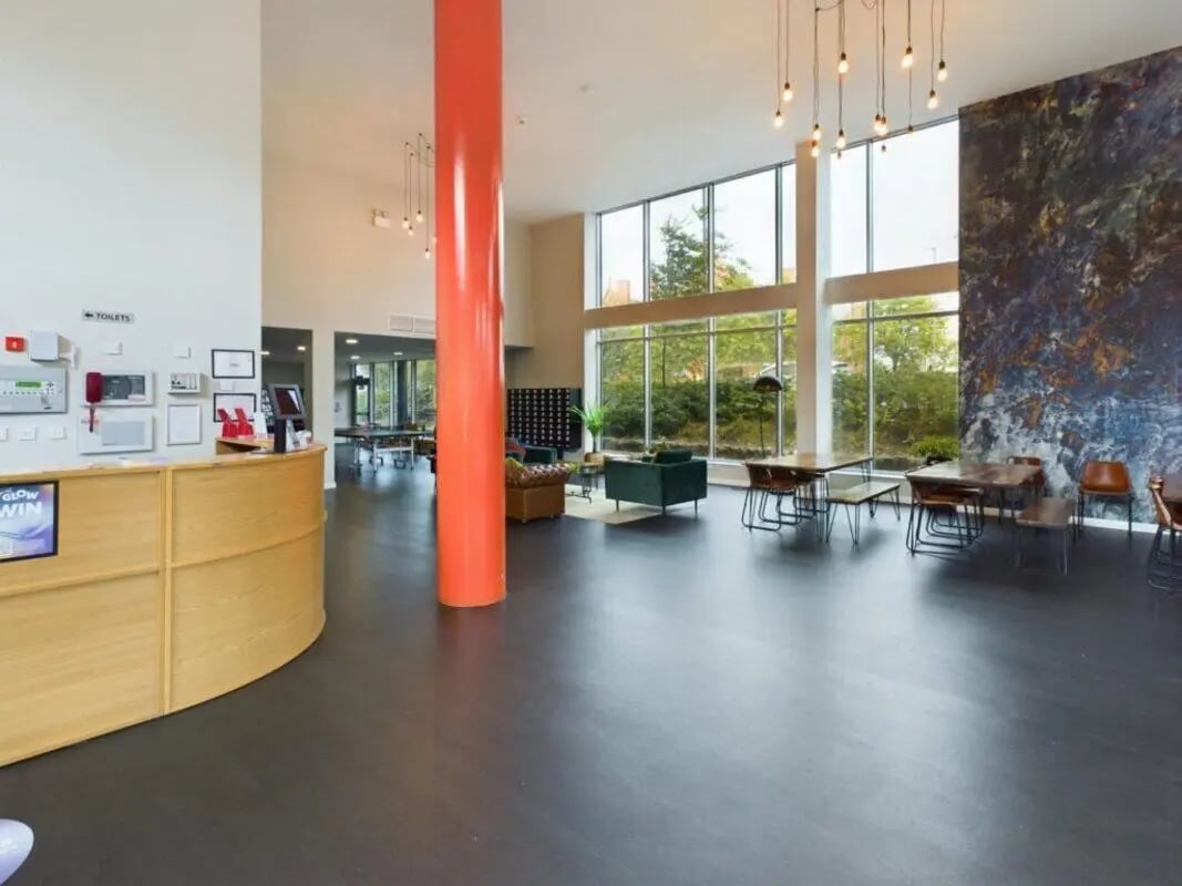 Reception desk sofas tables and ping pong tables common area at One Islington Plaza in Liverpool Student Accommodation