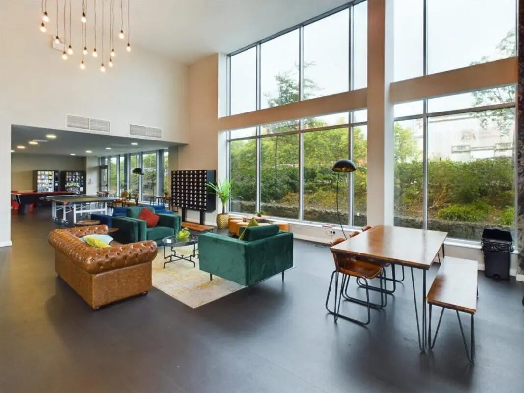 Modern living area with lounge seating and table Living Room at One Islington Plaza in Liverpool Student Accommodation