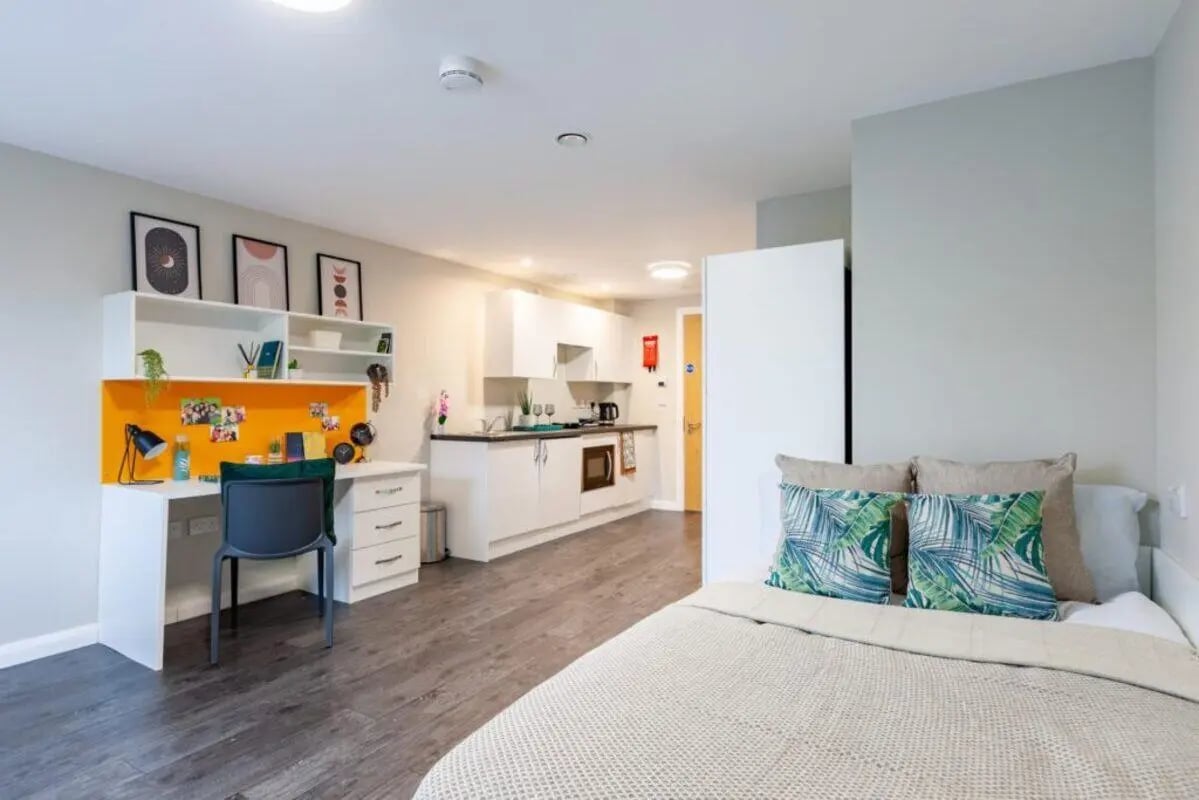 Bed desk and kitchen studio apartment at One Islington Plaza in Liverpool Student Accommodation
