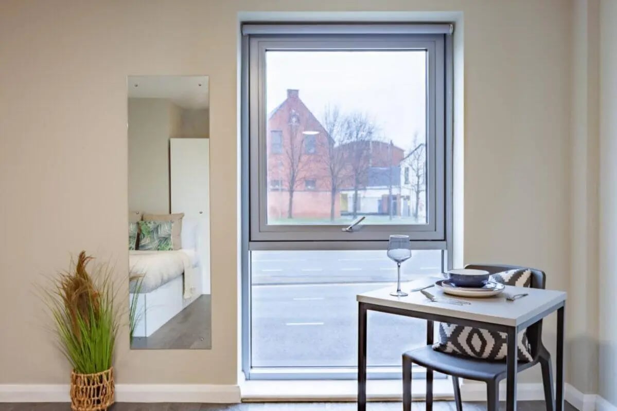 Table chairs glass mirror bed bedroom at One Islington Plaza in Liverpool Student Accommodation