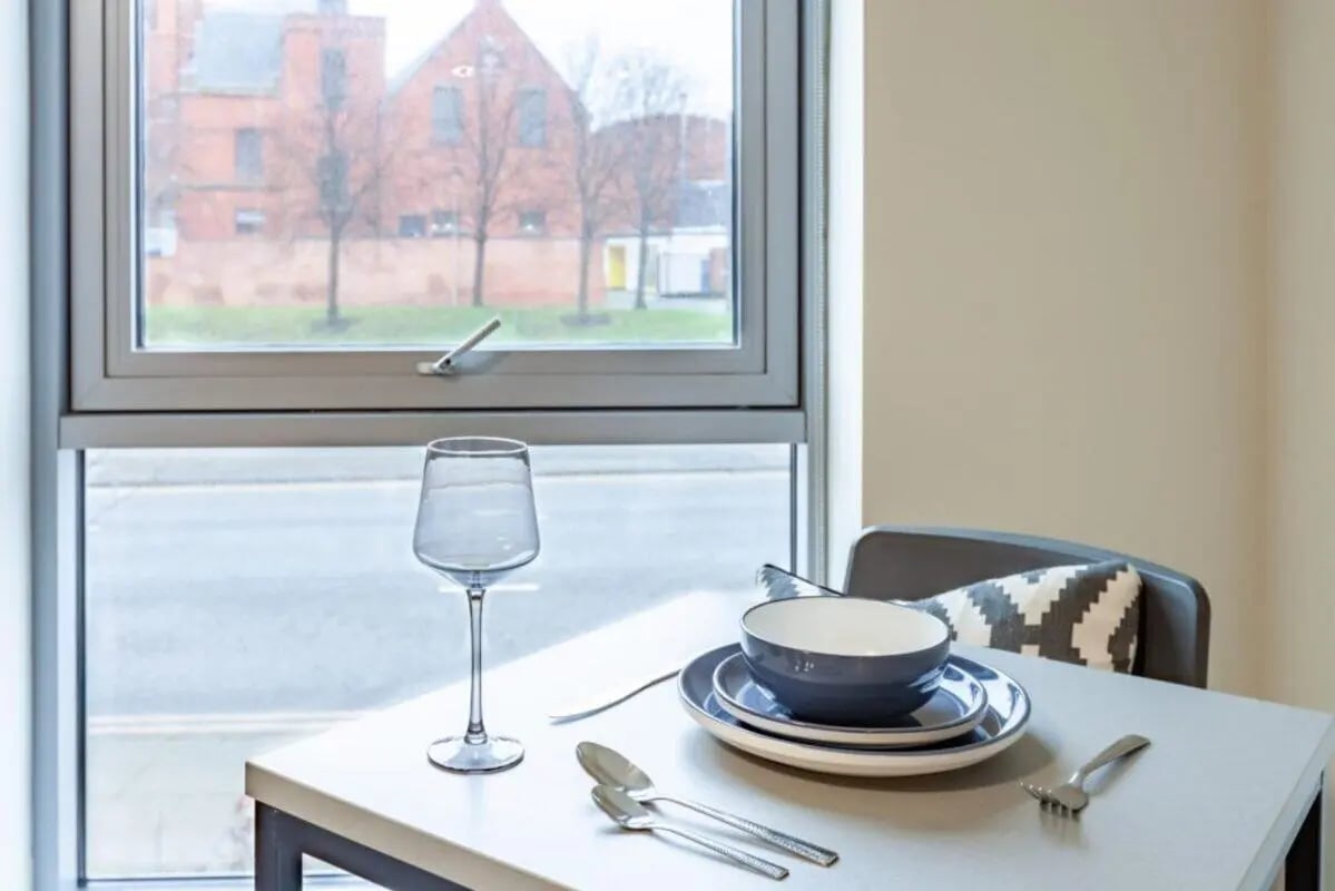 Table setting with glass bowl plates cutlery dining area at One Islington Plaza in Liverpool Student Accommodation