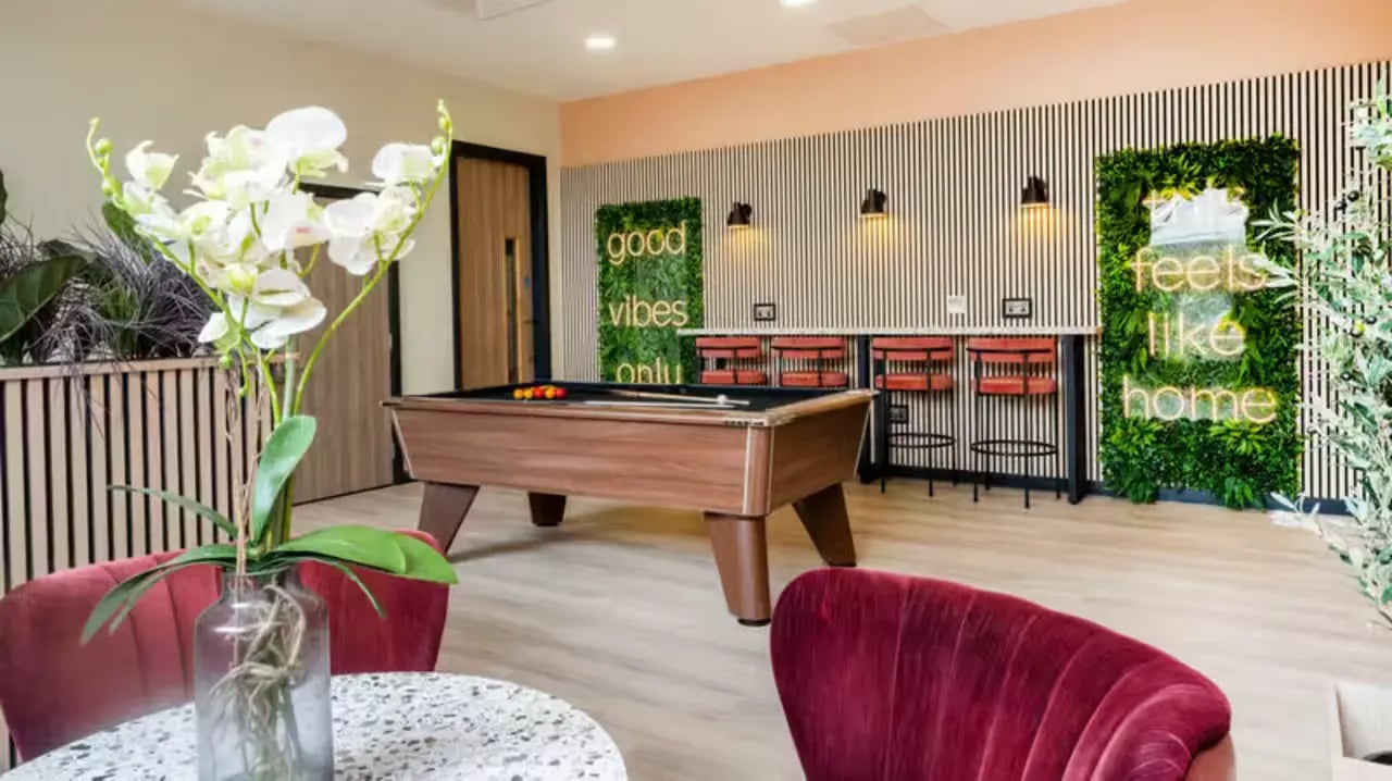Pool table, bar stools, neon signs, lounge area at Fontenoy Apartments in Liverpool Student Accommodation