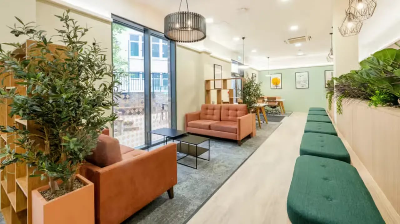 Orange sofas and green benches lounge area at Fontenoy Apartments in Liverpool Student Accommodation