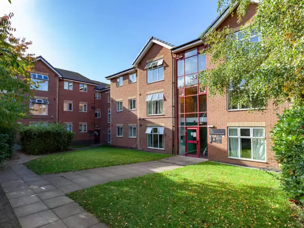 Brick building with glass entrance and lawn exterior at Paddington Park House in Liverpool Student Accommodation