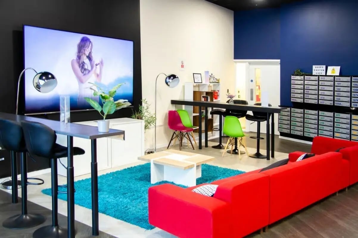 Large TV red sofa blue rug living area at The Cube Ealing in London Student Accommodation