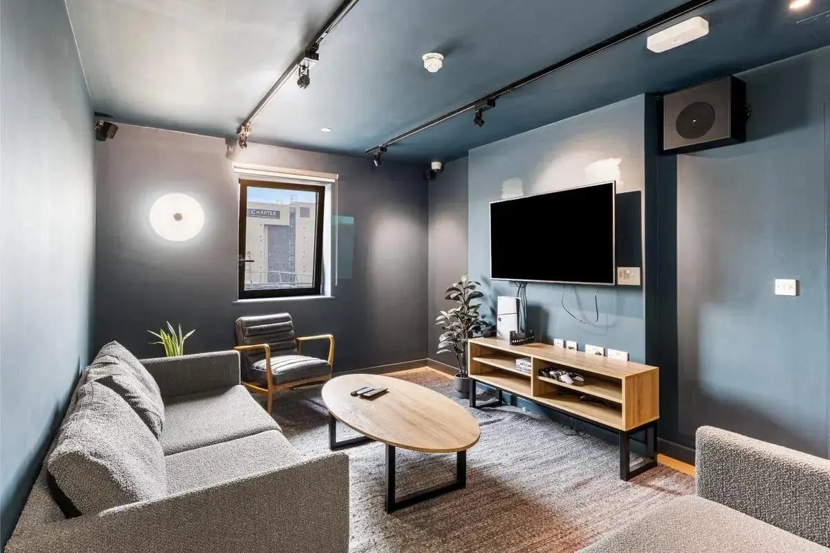 Sofa chairs oval table TV living room at Chapter Highbury II in London Student Accommodation