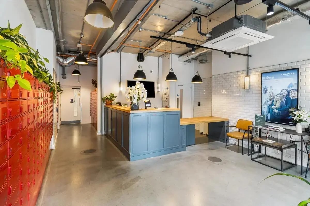 Reception desk with lockers and seating area at Chapter Highbury II in London Student Accommodation