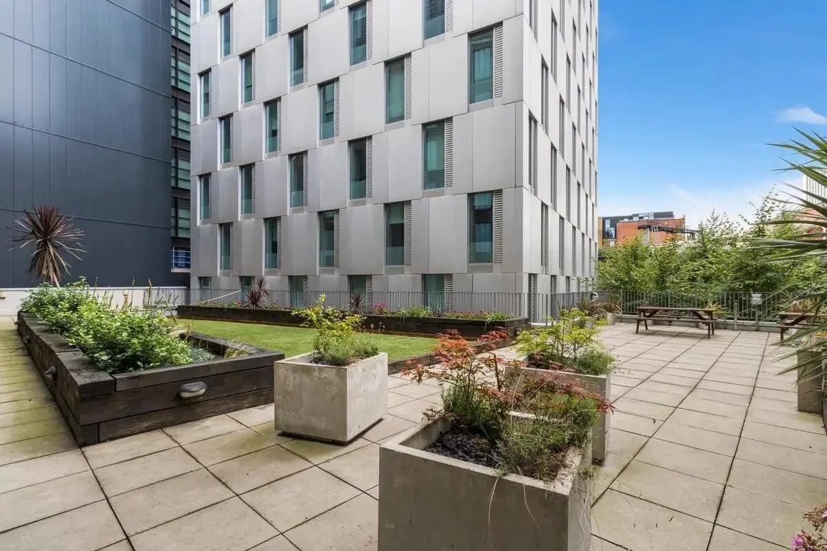 Courtyard with plants picnic tables and building exterior exterior at Chapter South Bank in London Student Accommodation