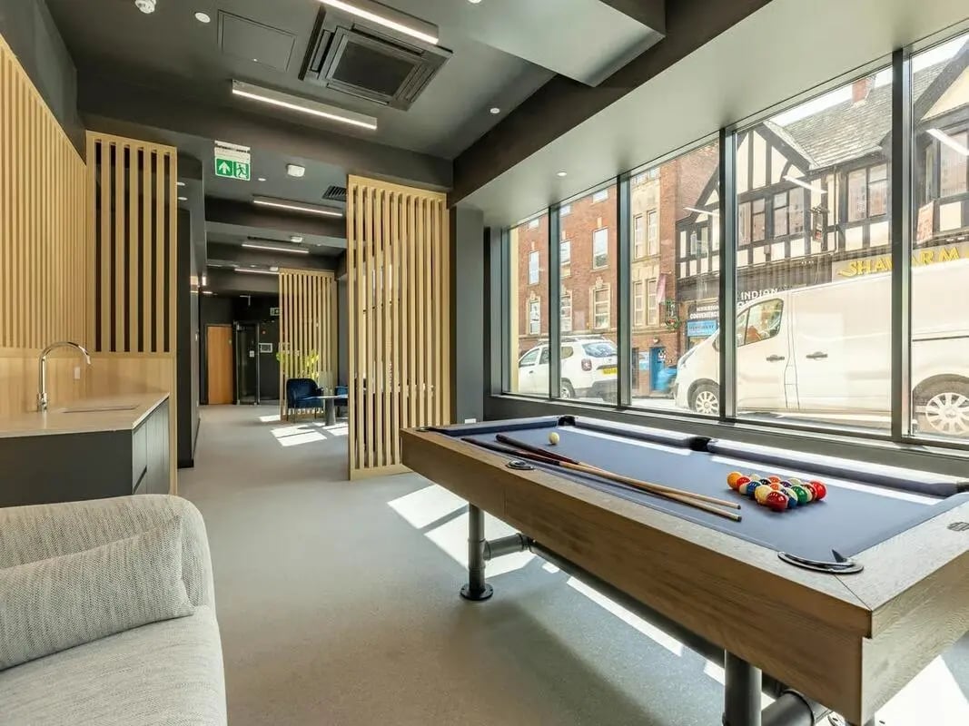 Pool table with balls and cues communal area at Straits Aire in Leeds Student Accommodation