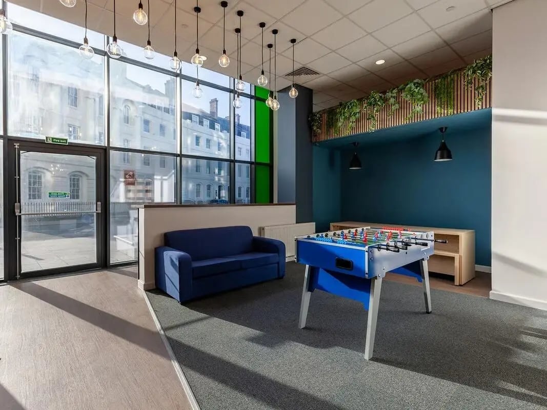 Blue sofa foosball table communal room at Saltwater Place in Plymouth Student Accommodation