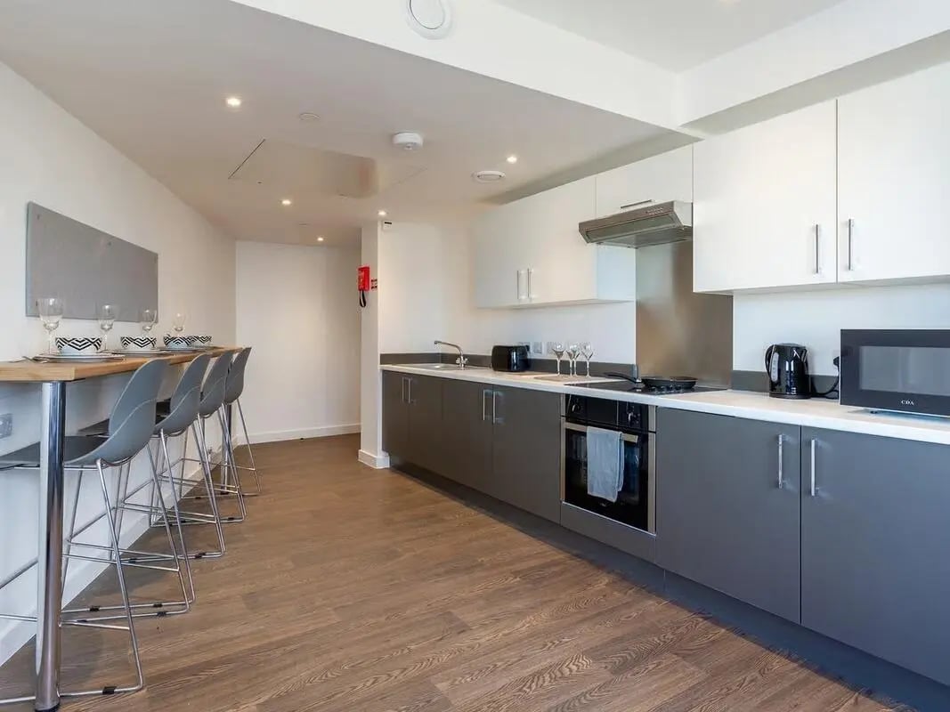 Modern kitchen with bar stools and appliances kitchen at Saltwater Place in Plymouth Student Accommodation
