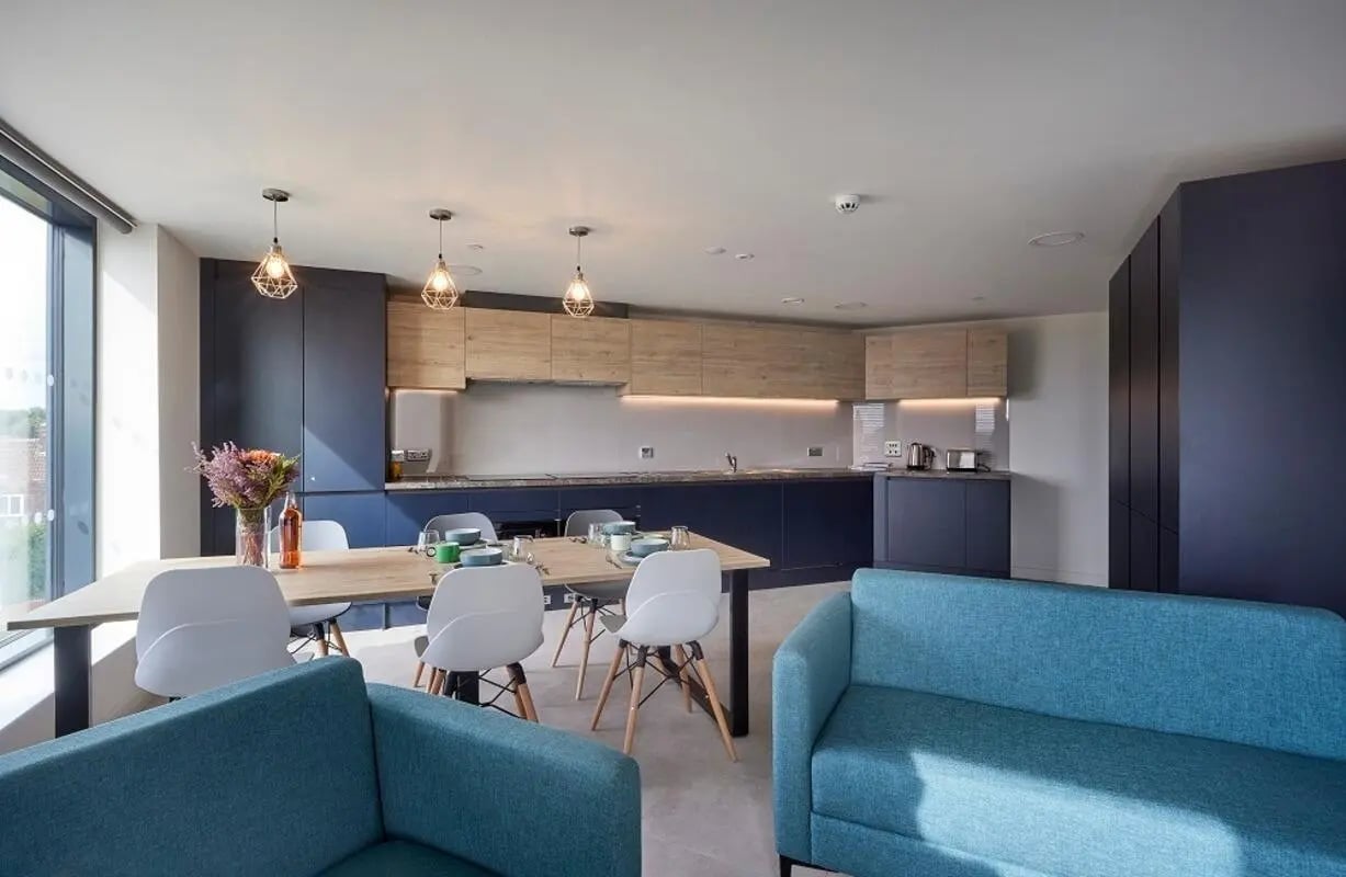 Kitchen with table sofas and modern cabinets kitchen at Regatta Place in Durham Student Accommodation