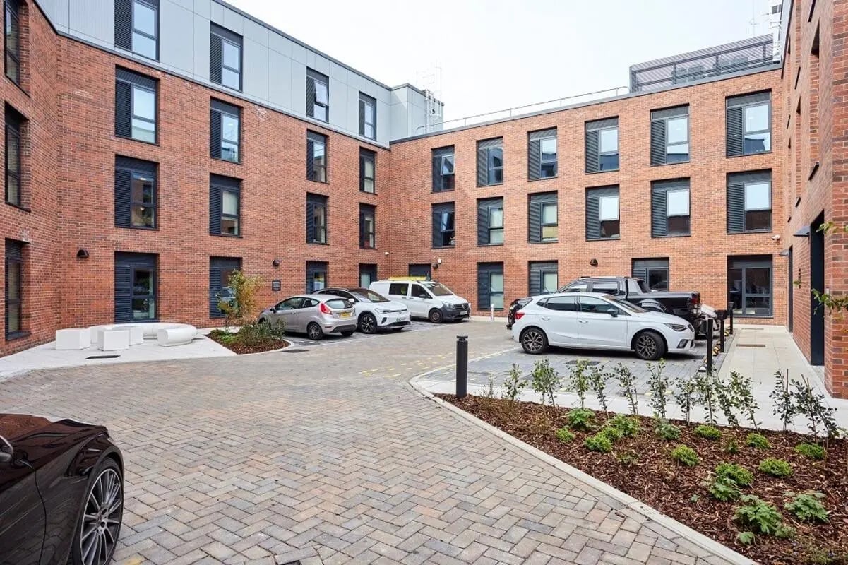 Apartment building cars parked and landscaping exterior at Regatta Place in Durham Student Accommodation