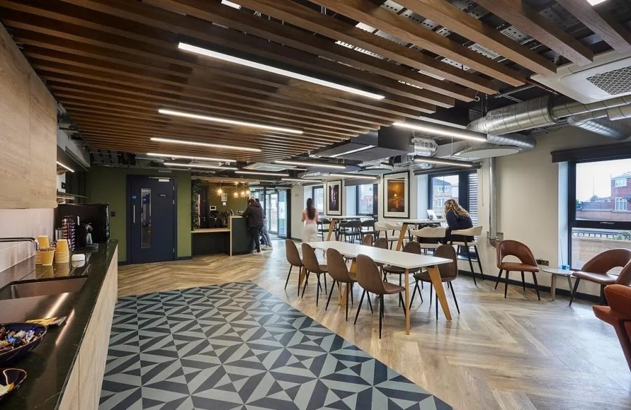 Communal area with tables chairs and coffee machine living room at Regatta Place in Durham Student Accommodation