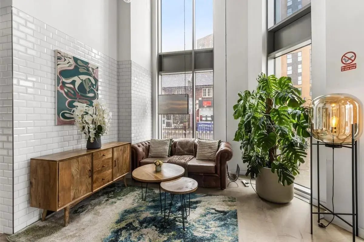 Brown leather sofa, wood cabinet, modern lamp living room at Chapter White City in London Student Accommodation