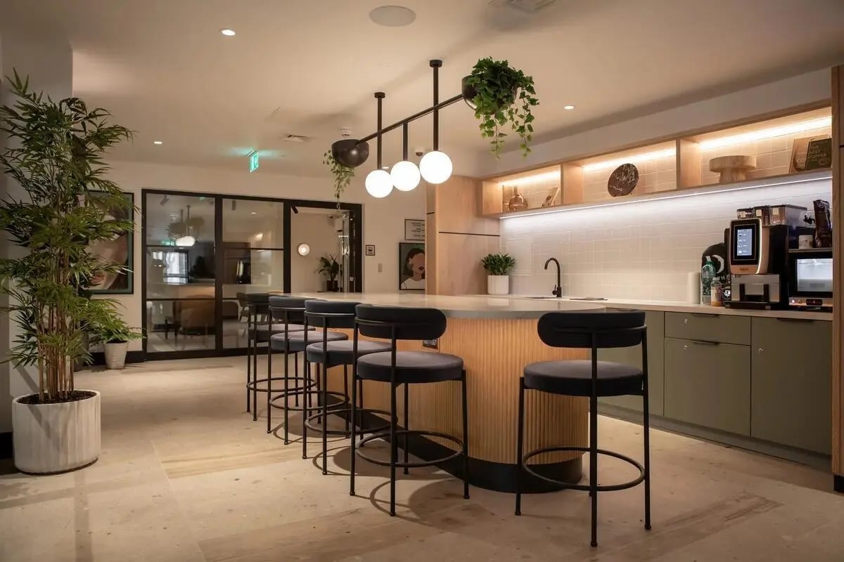 Bar stools at kitchen counter with plants kitchen at Centre Court in Nottingham Student Accommodation