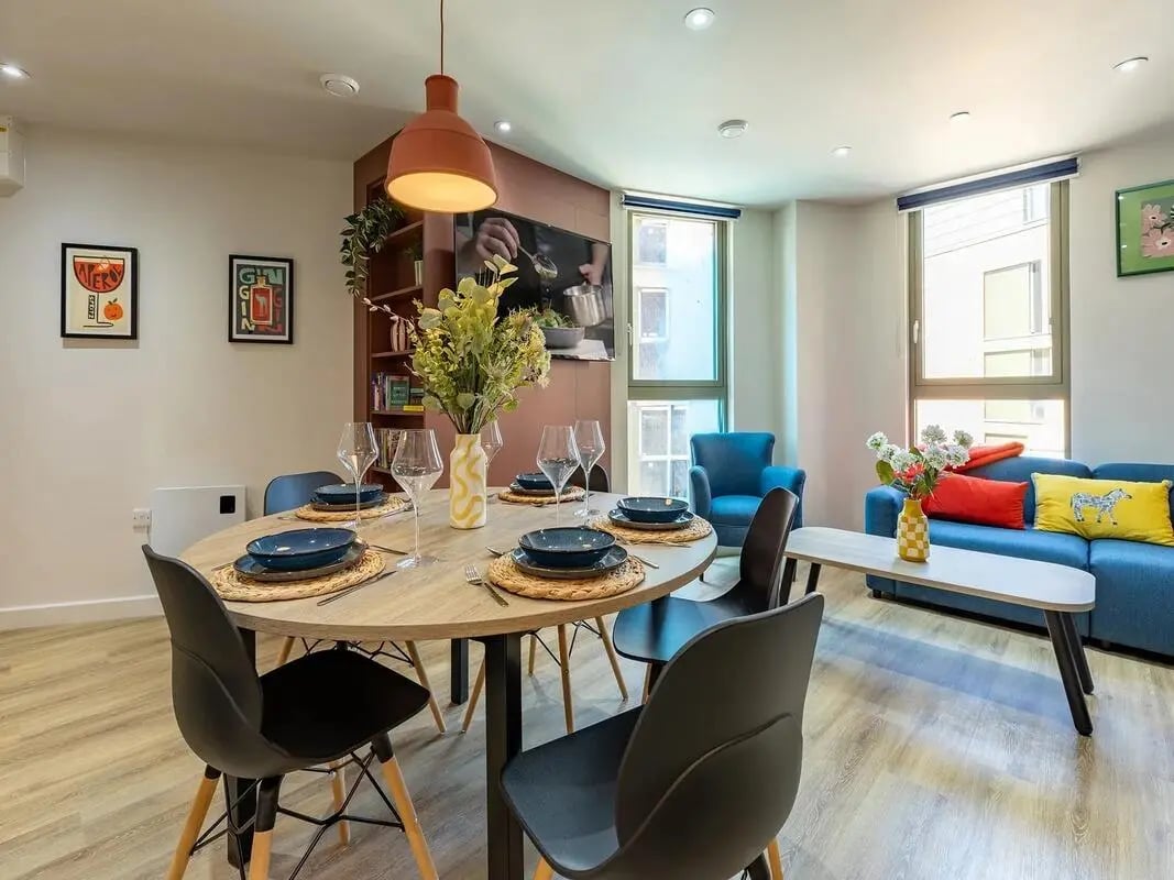Dining table with place settings and chairs living area at Centre Court in Nottingham Student Accommodation