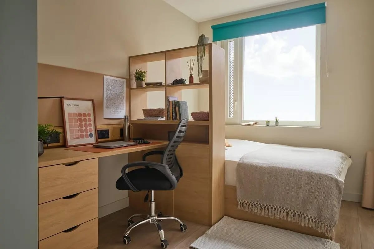 Desk bed shelves and chair bedroom area at Ark Canning Town in London Student Accommodation