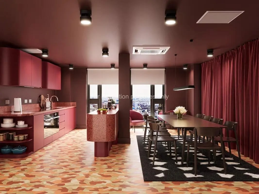Modern kitchen and dining area with red cabinets and table at St Vincent Studios in Glasgow Student Accommodation