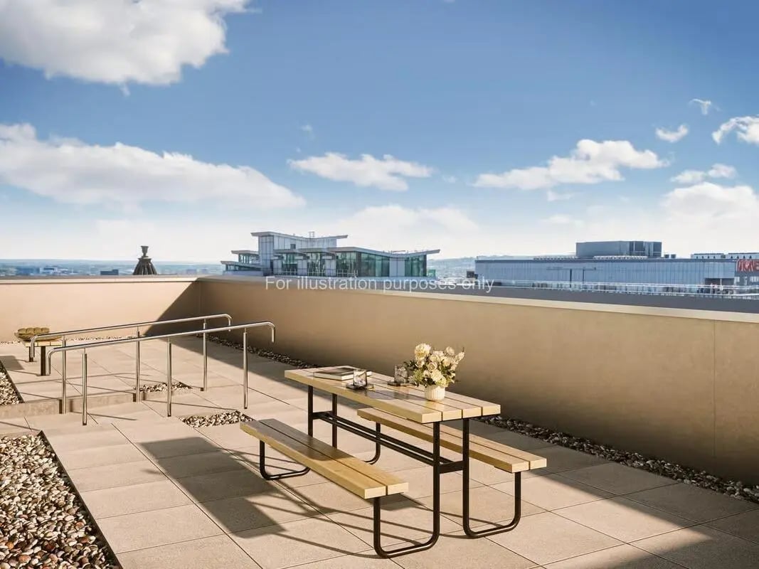 Picnic table with benches and flowers patio exterior at St Vincent Studios in Glasgow Student Accommodation