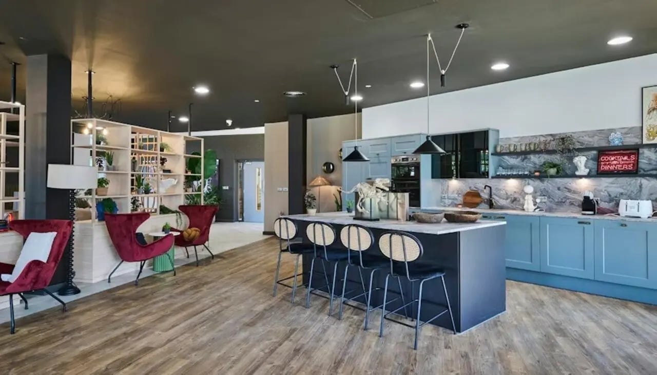 Kitchen island bar stools with blue cabinets kitchen at Deakins Place in Nottingham Student Accommodation