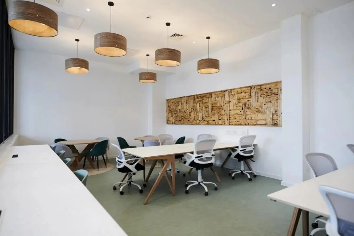 Tables chairs and large pendant lights Study area at Canvas Walthamstow in London Student Accommodation