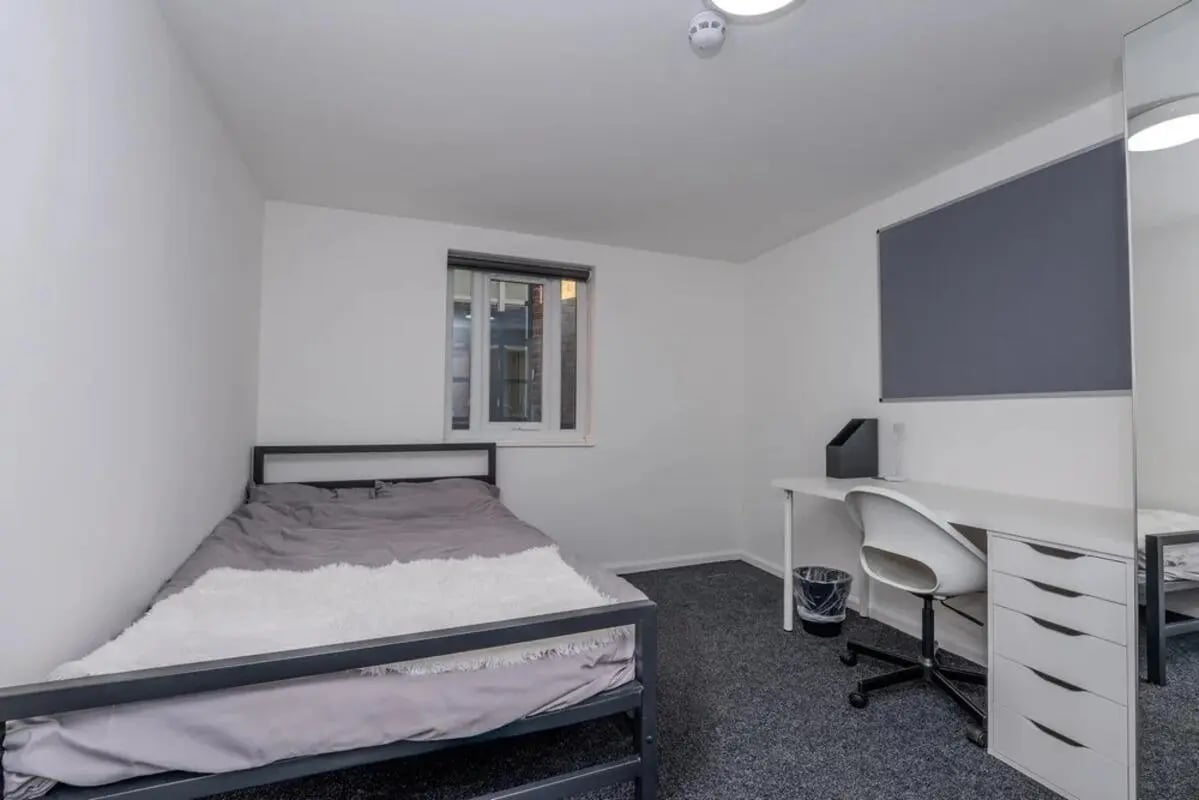 Bed desk chair and bin bedroom at Bertrand Russell House in Nottingham Student Accommodation