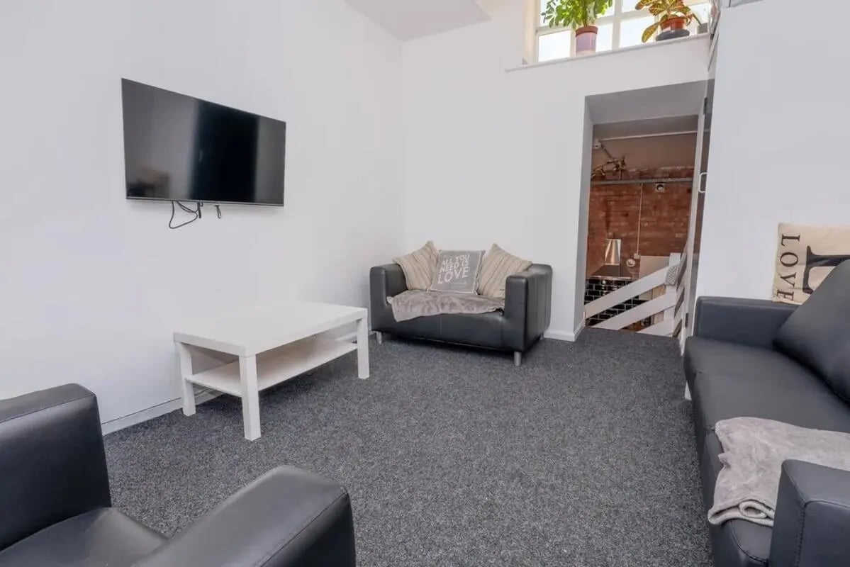 Sofa television white table living room at Bertrand Russell House in Nottingham Student Accommodation