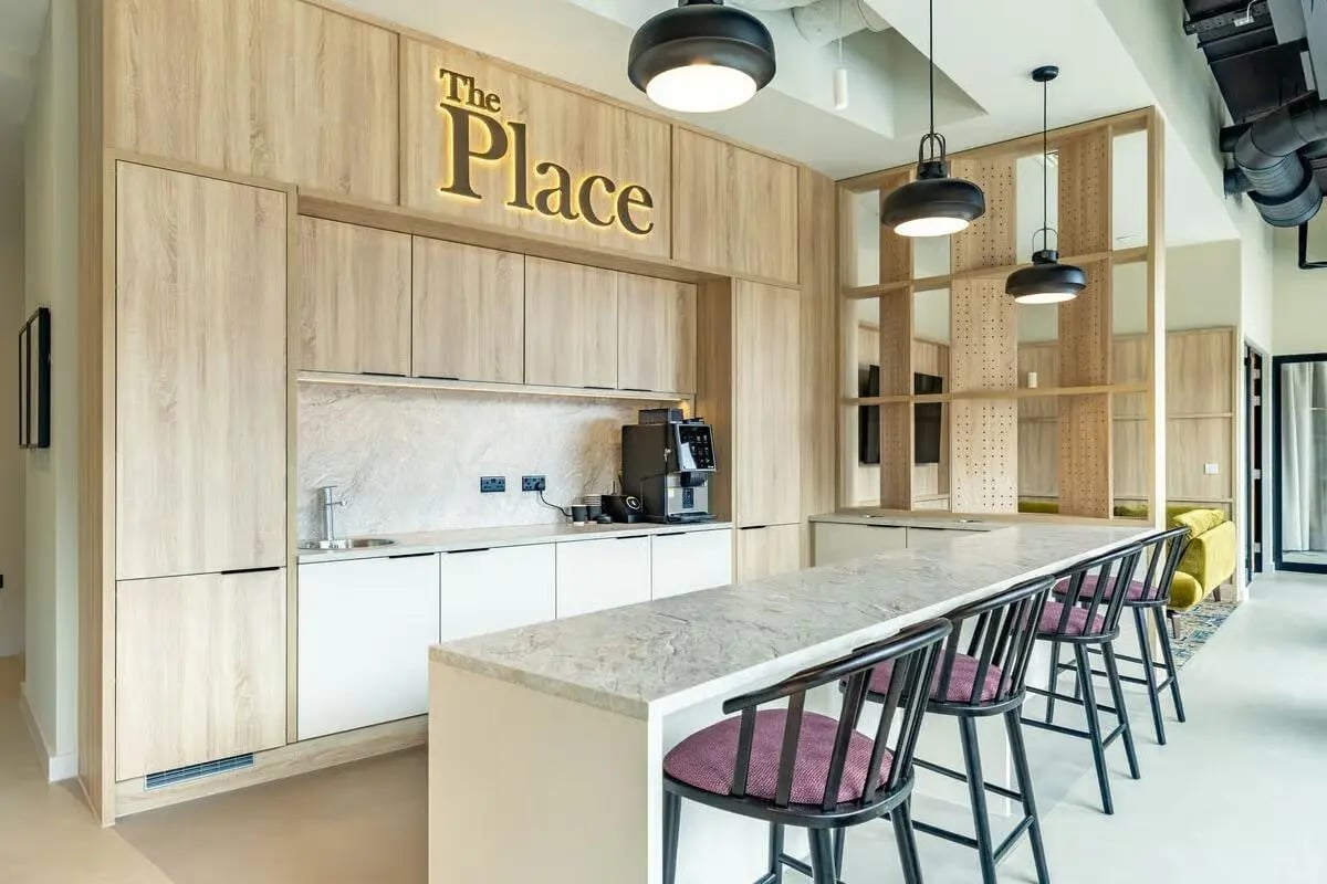 Kitchen island with stools coffee machine wooden cabinets kitchen at The Place in Nottingham Student Accommodation