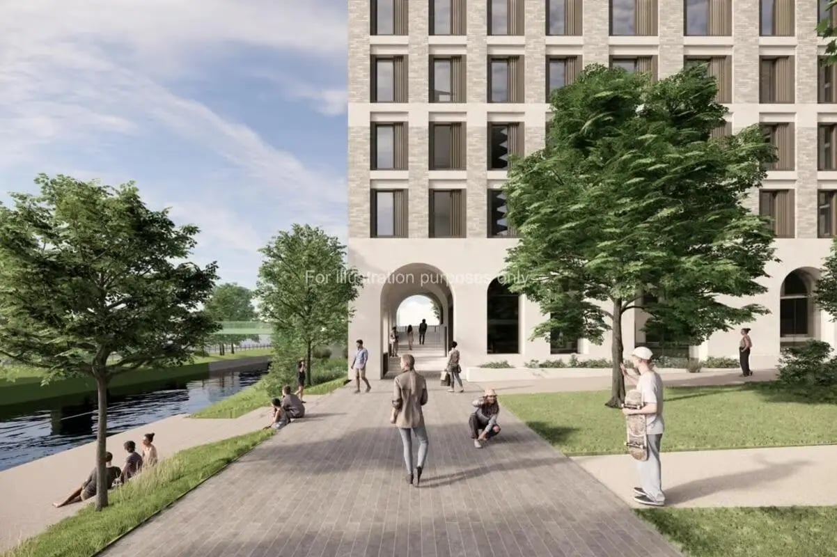People by river and building exterior at Timber Yard in Bristol Student Accommodation