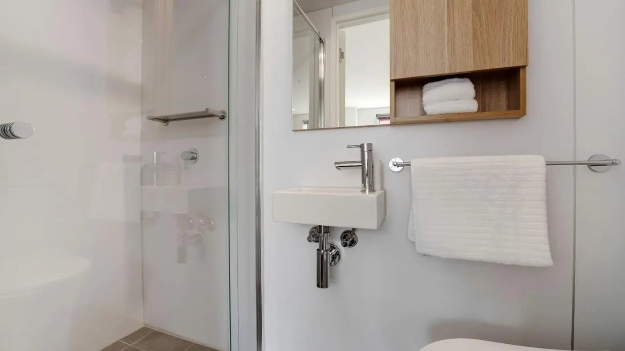 Sink mirror shower and towel Bathroom at UniLodge Auckland Central in Auckland Student Accommodation