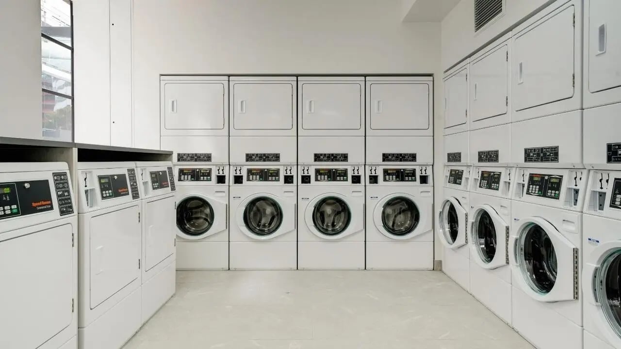 Washing machines and dryers stacked in rows Laundry room at UniLodge Auckland Central in Auckland Student Accommodation
