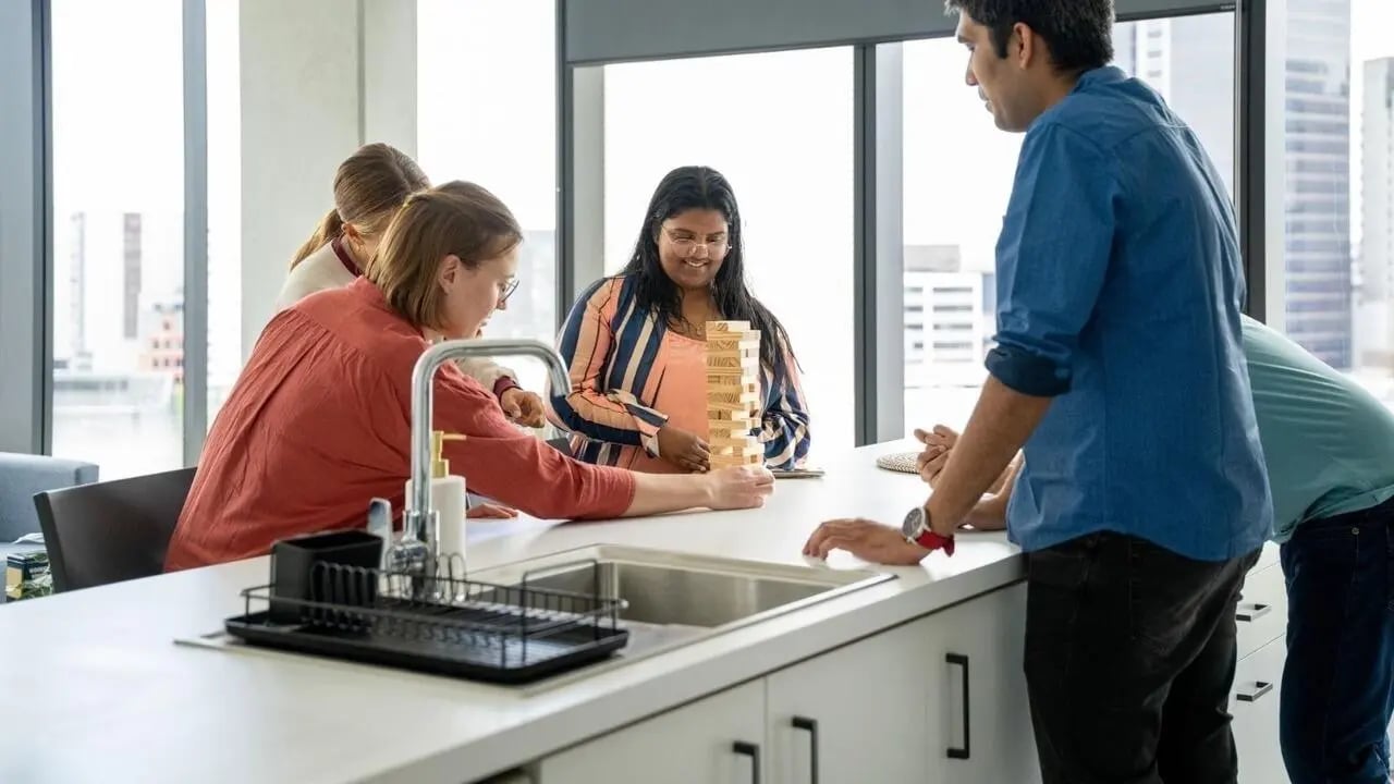 People play Jenga near sink kitchen area at UniLodge Auckland Central in Auckland Student Accommodation
