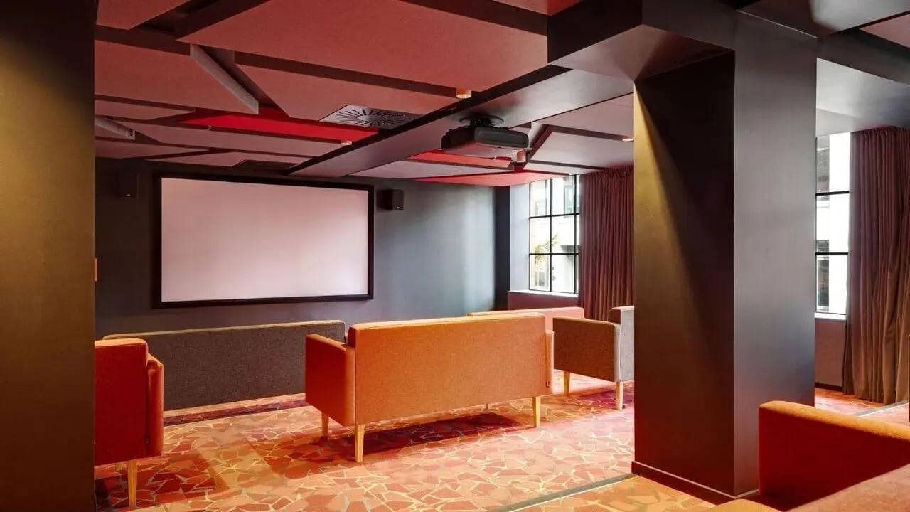 Projector screen couches and red floor movie room at UniLodge Auckland Central in Auckland Student Accommodation