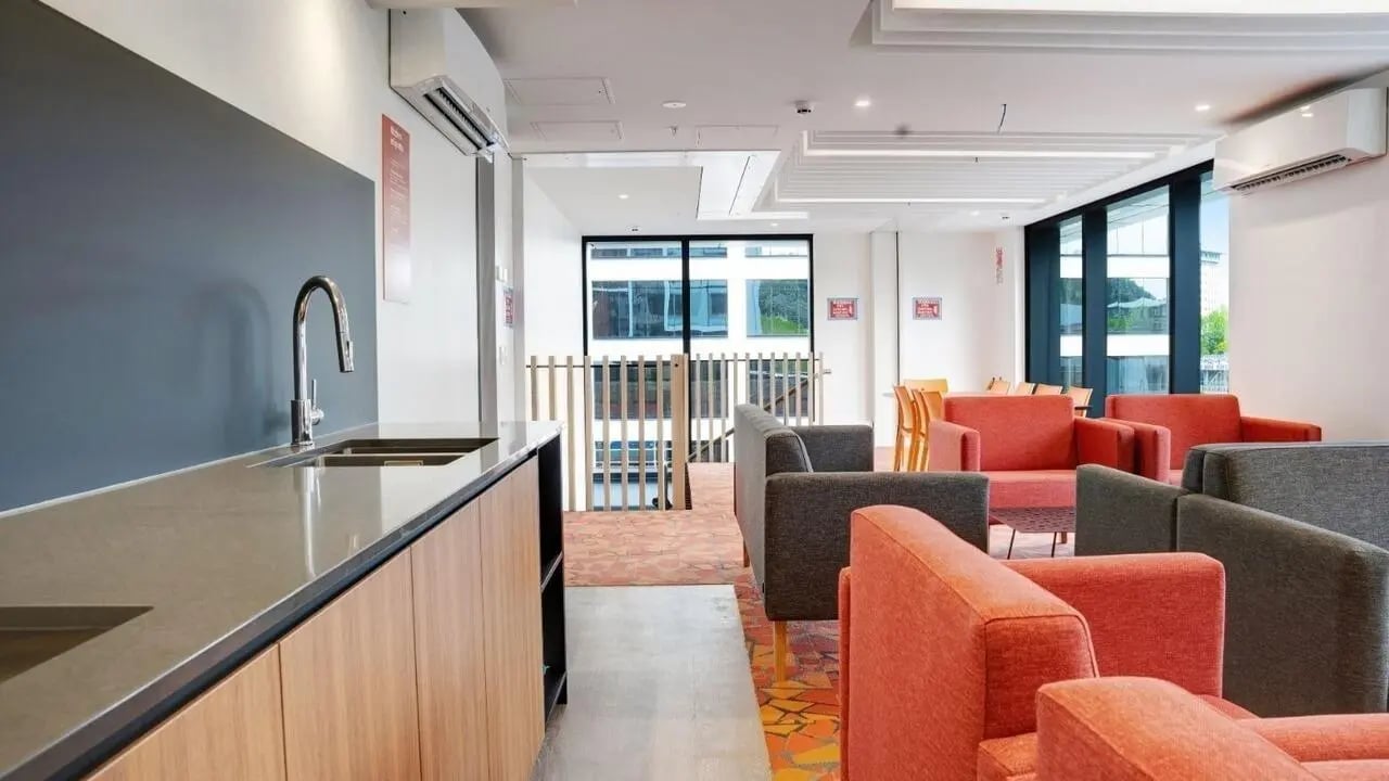 Modern common room with sink and seating area at UniLodge Auckland Central in Auckland Student Accommodation